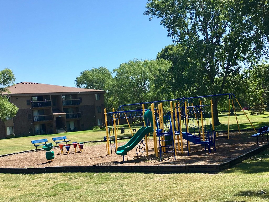 a playground with a building in the background