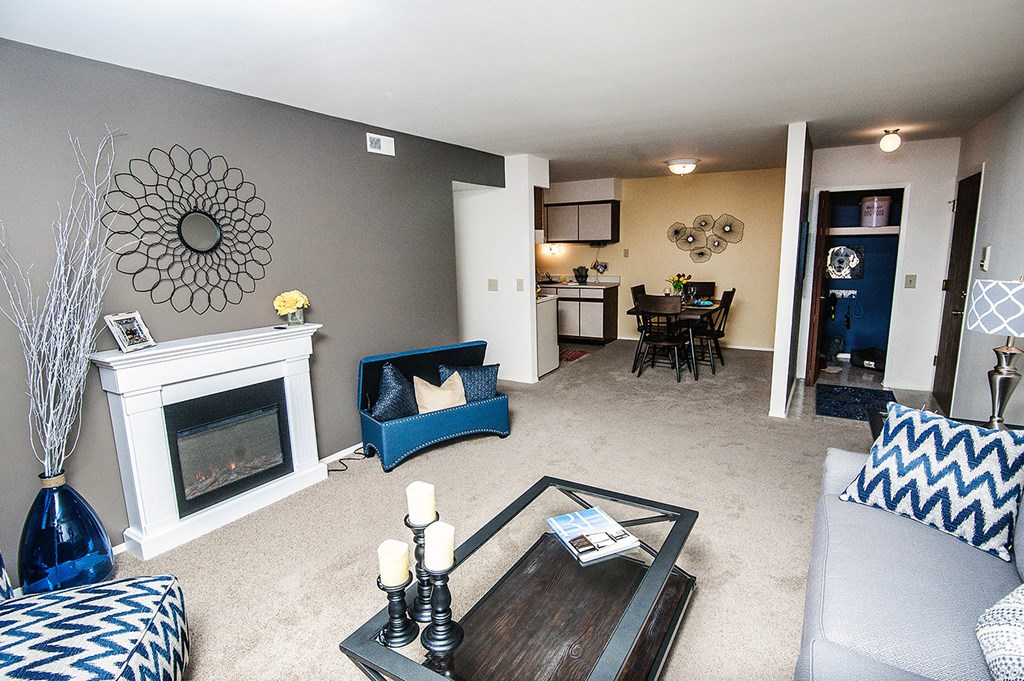 a living room with a fireplace and a table