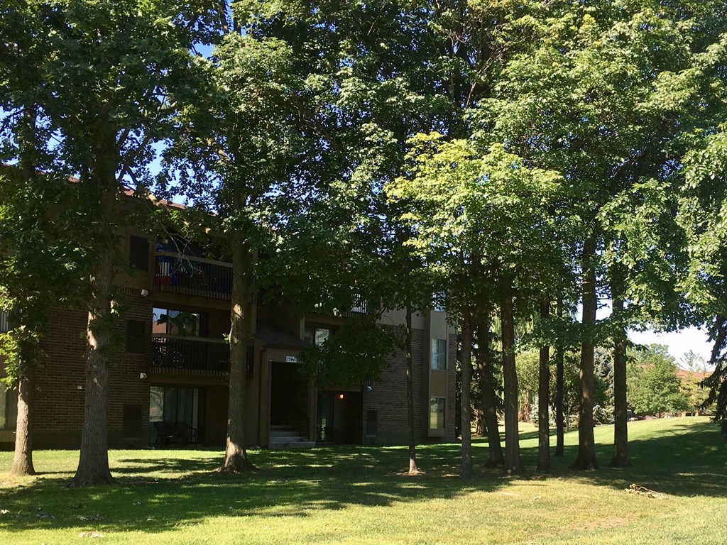 a large brick building with trees in front of it