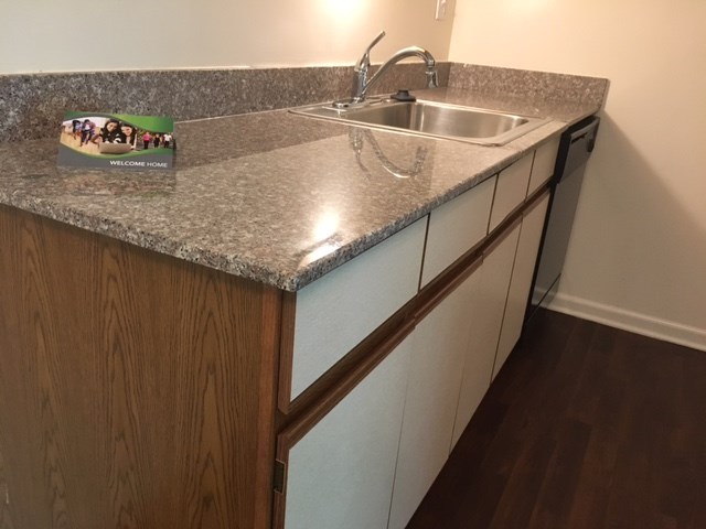 a kitchen with a granite counter top and a sink