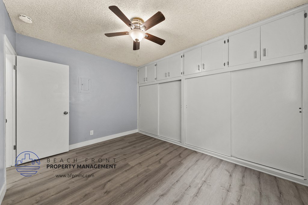 the master bedroom has a large walk in closet and a ceiling fan