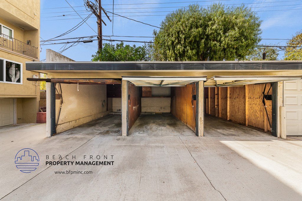 a parking lot with a garage door and a building