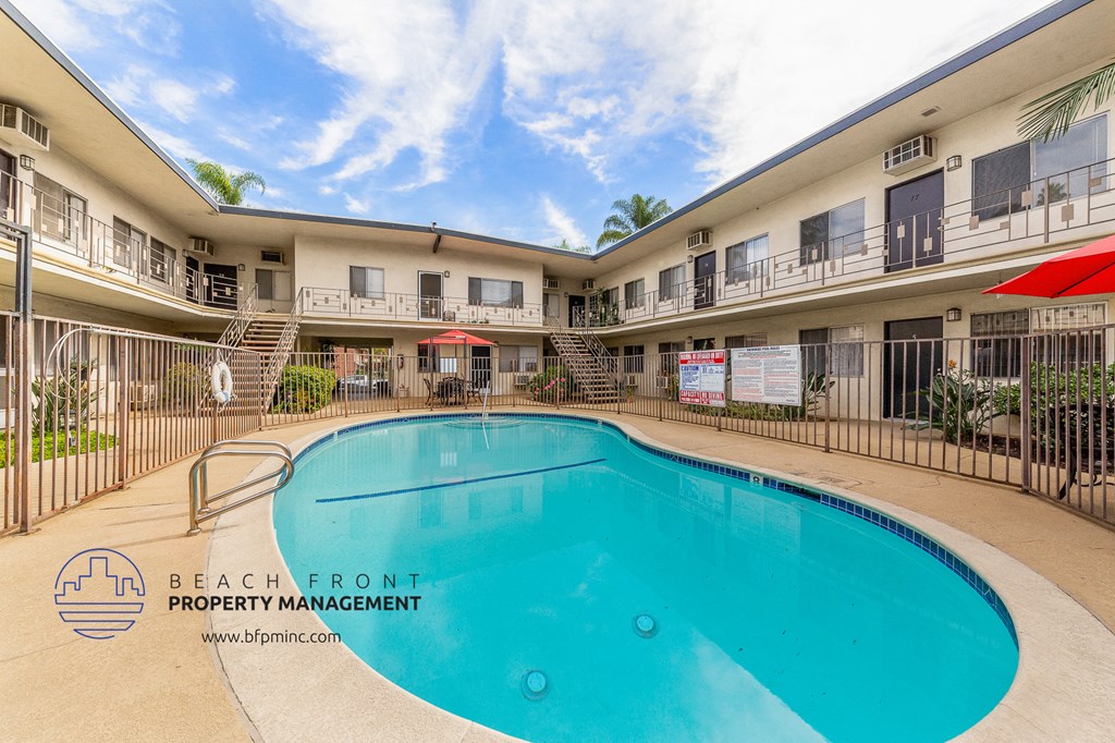 a swimming pool is available in the courtyard of a hotel with apartments