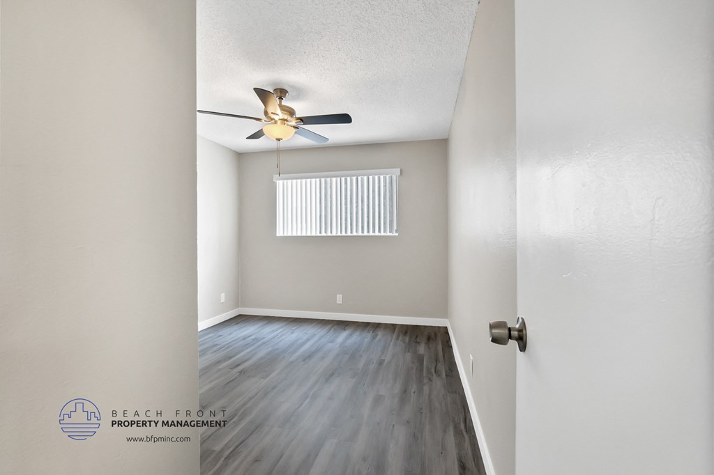 the bedroom of the bridgewater condos with hardwood flooring and a ceiling fan