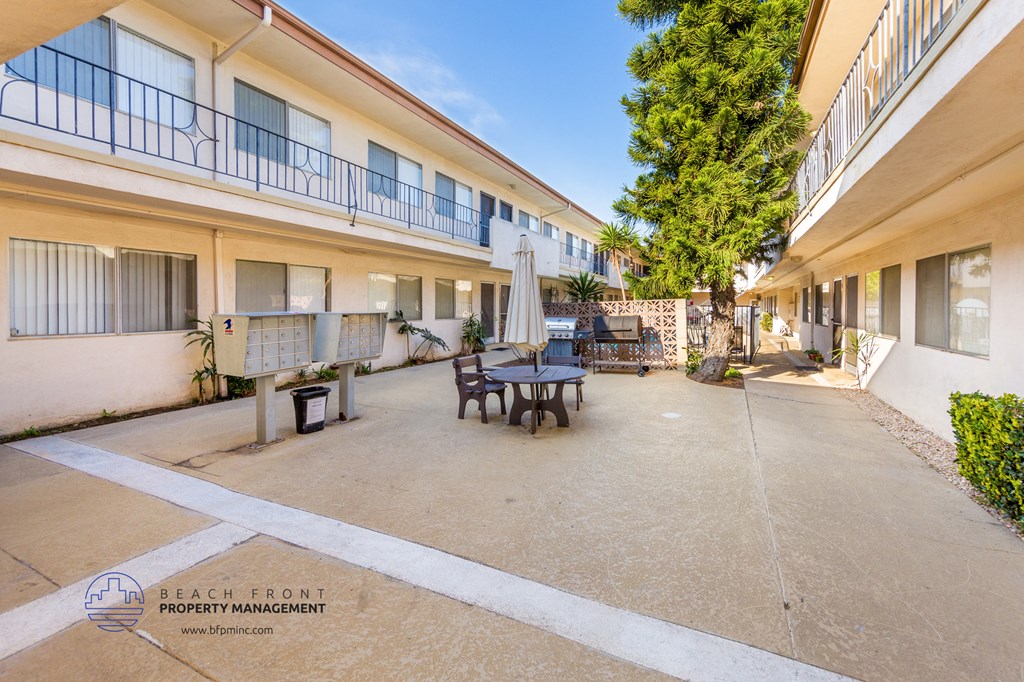 a patio with a table and chairs in a courtyard