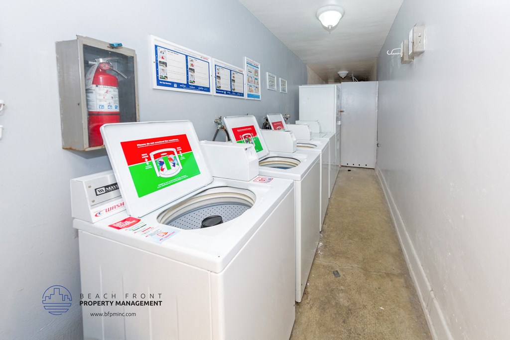 a row of washers and dryers in a laundry room