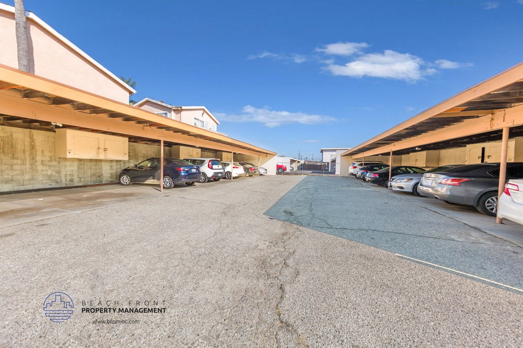 a parking lot with cars parked on the side of a building