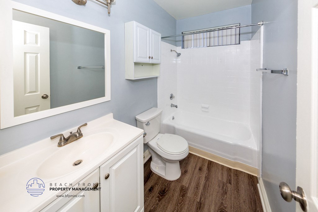 a bathroom with a shower toilet and sink and a mirror