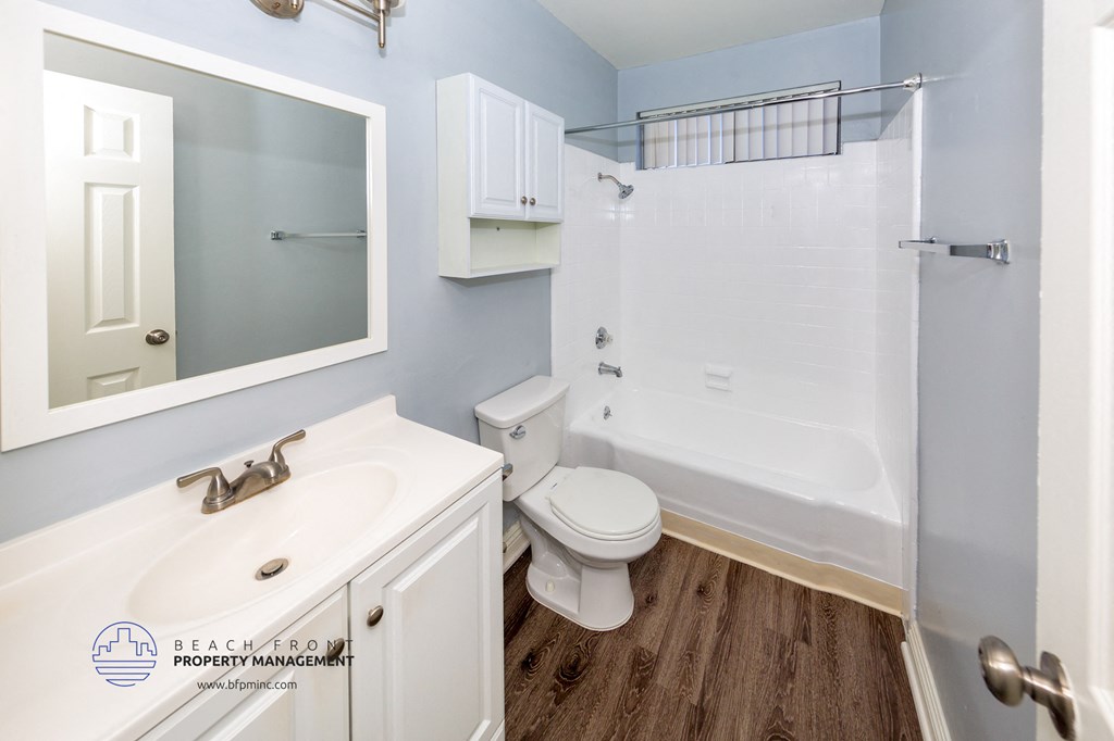 a bathroom with a shower toilet and sink and a mirror