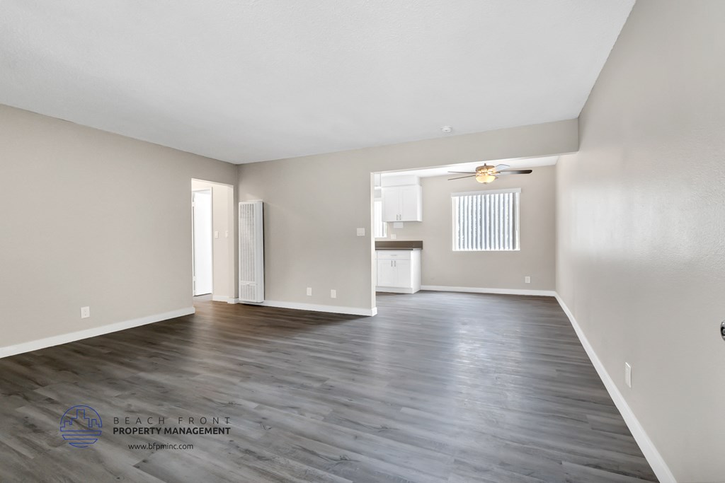 the living room and kitchen of an empty renovated house