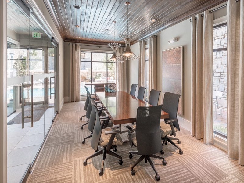 a conference room with a long wooden table and chairs