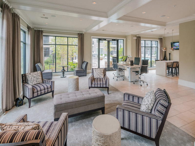 a large living room with chairs and a table