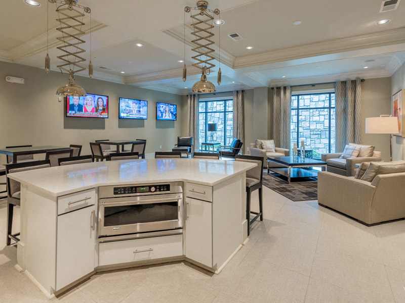 a kitchen with an island and a living room with couches