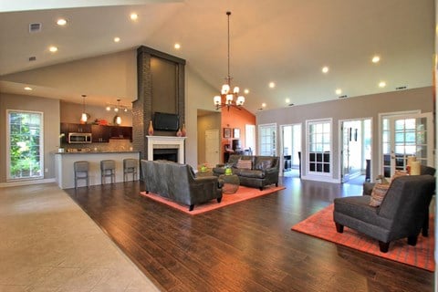 a large living room with furniture and a fireplace