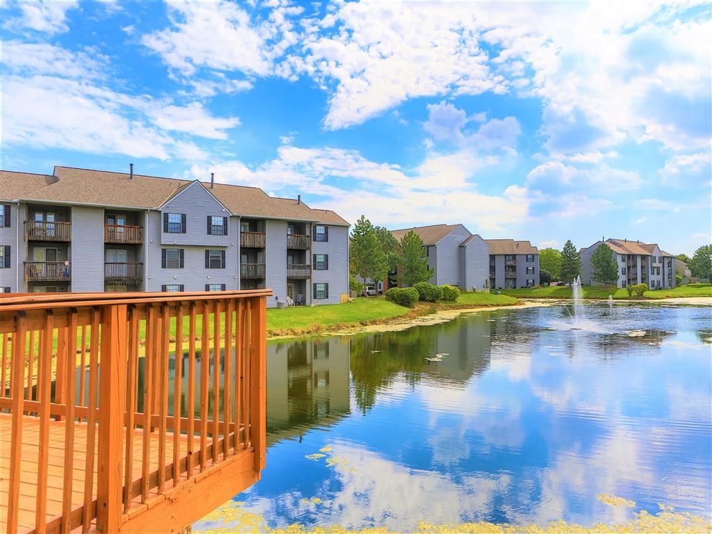 a view of a lake with apartment buildings overlooking it