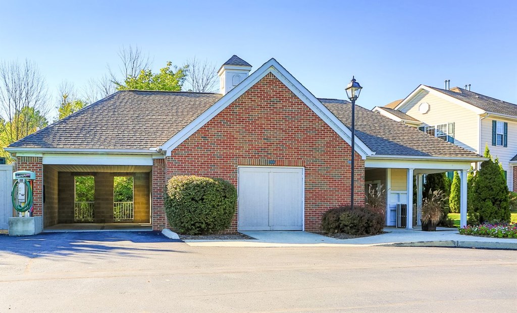 the front of a brick house with a white garage door