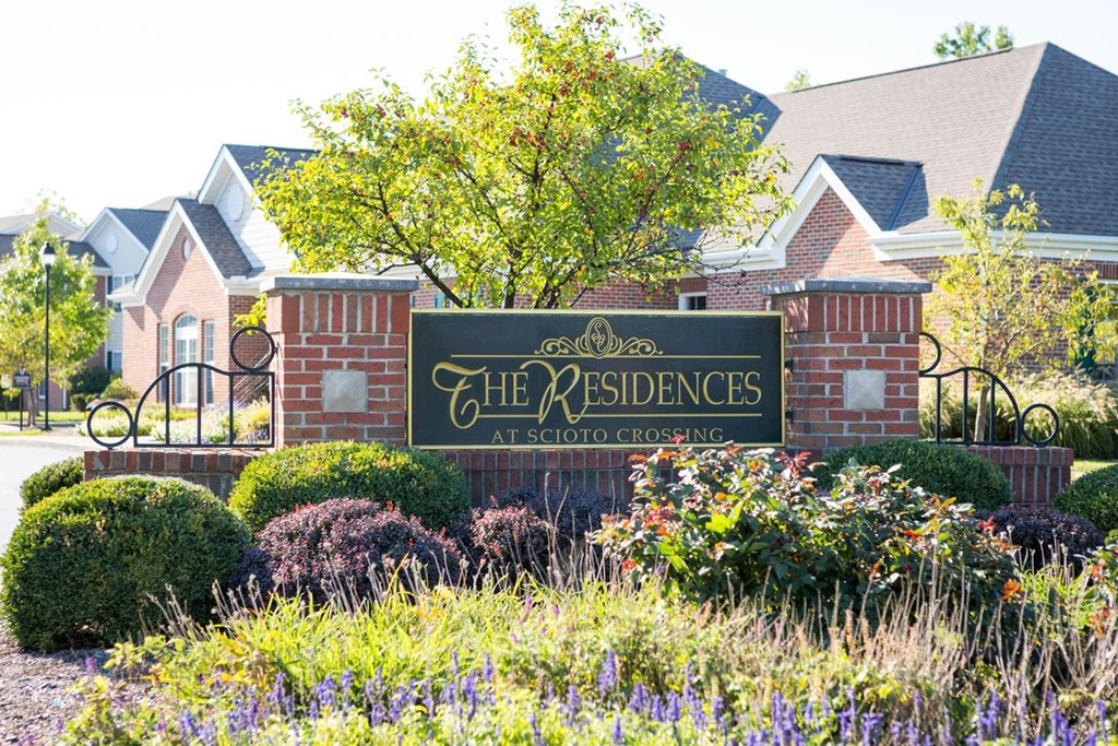 the neighborhood sign in front of a house