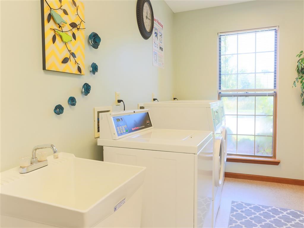 a laundry room with two sinks and a washing machine