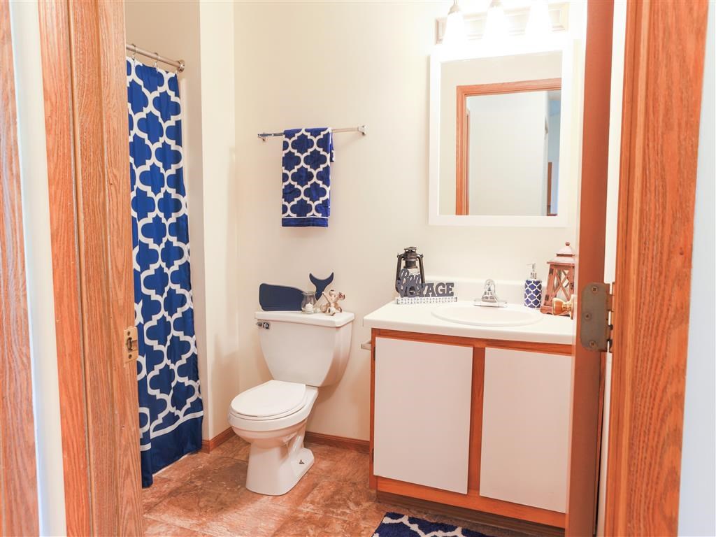 a bathroom with a toilet and a sink and a curtain