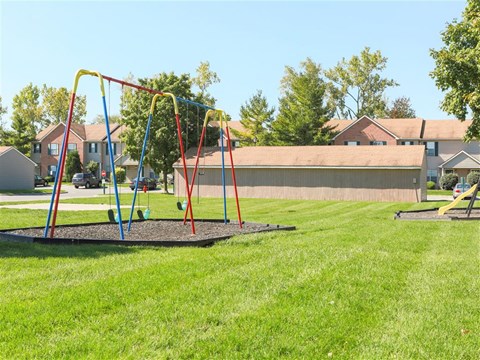 a swing set on a playground in a park