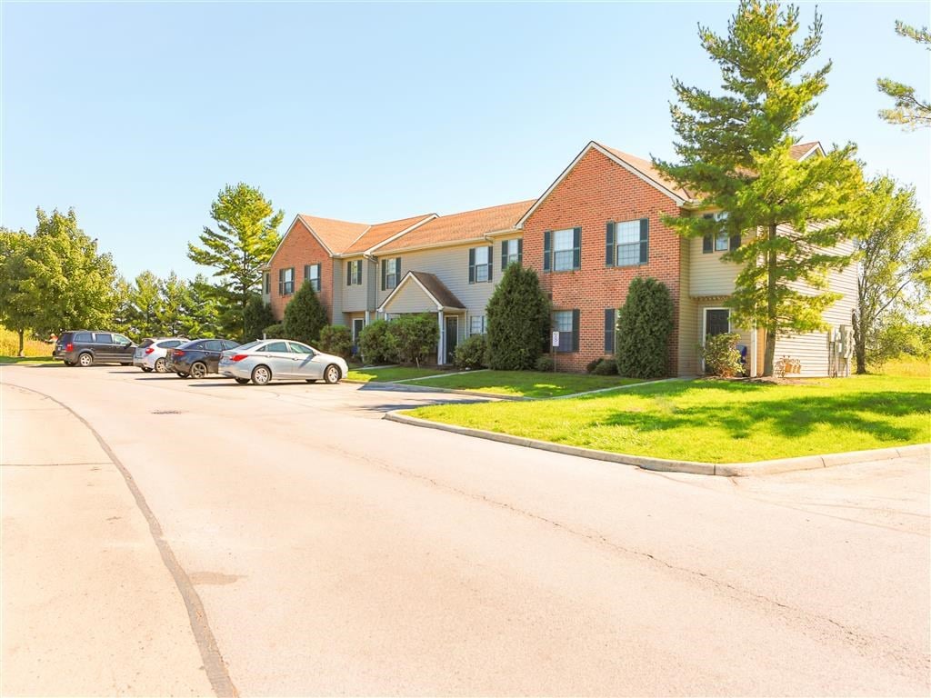 a large house with cars parked in front of it