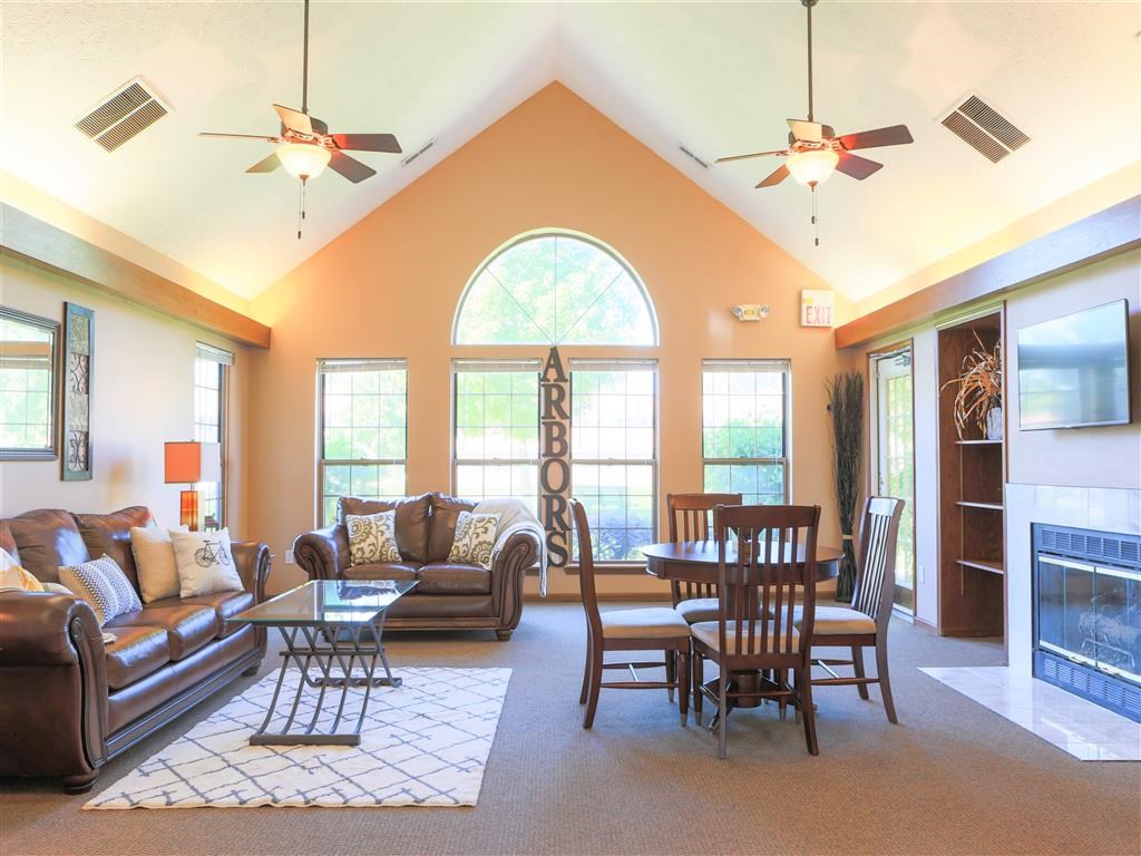 a living room with couches and a table and a fireplace