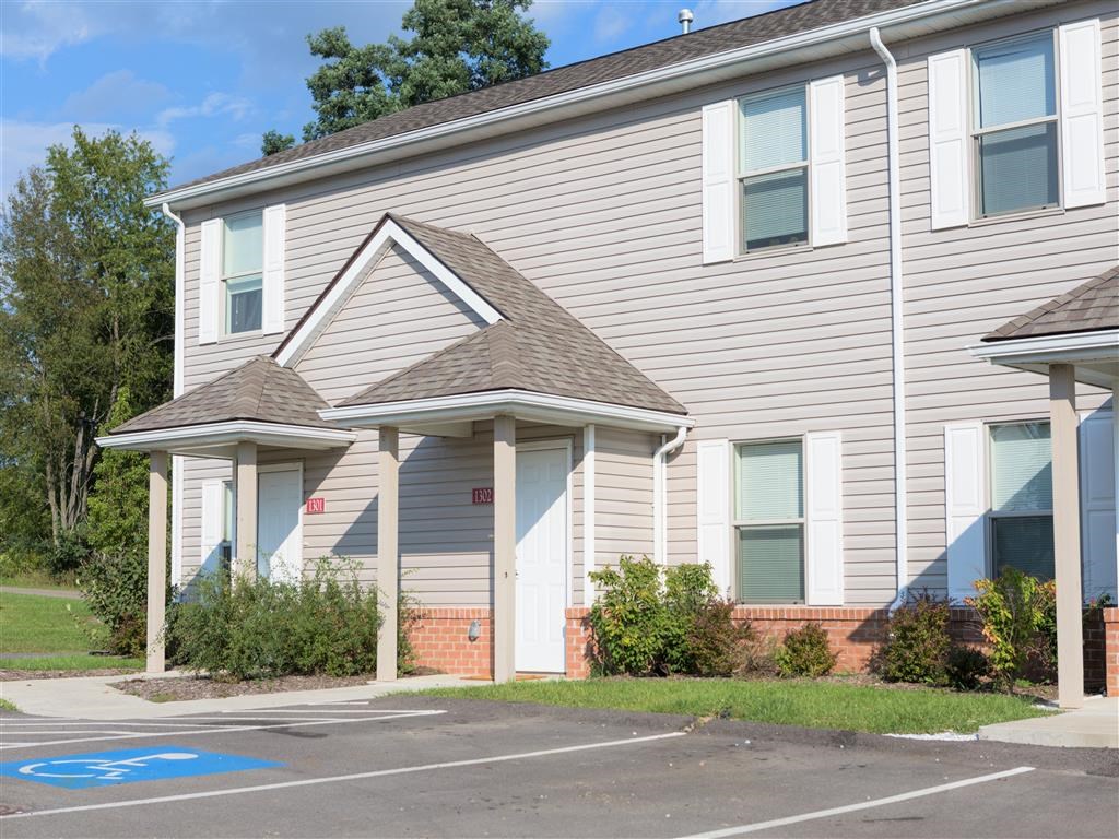 a white house with a blue parking lot