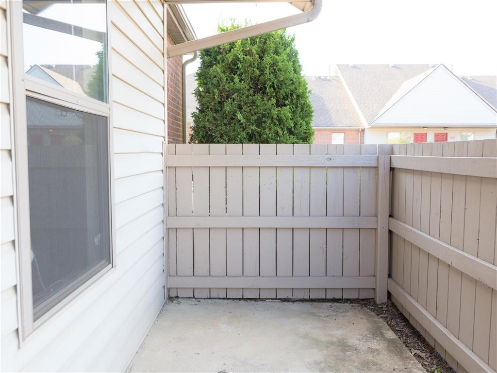 a white fence in front of a house with a window