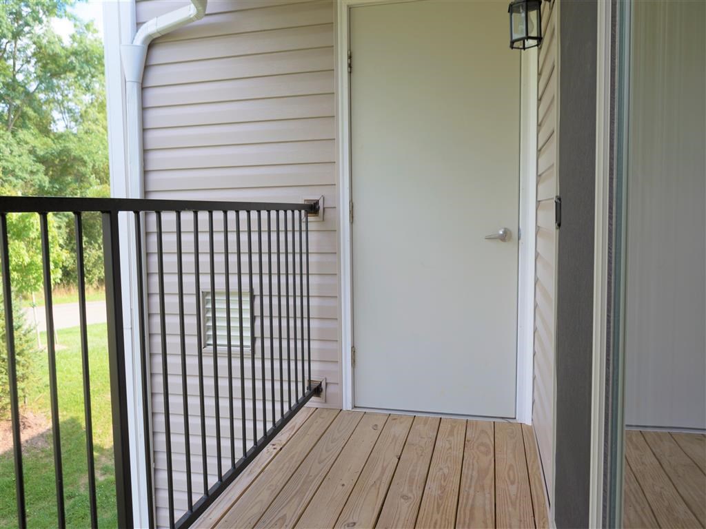 the view from the deck of a house with a white door