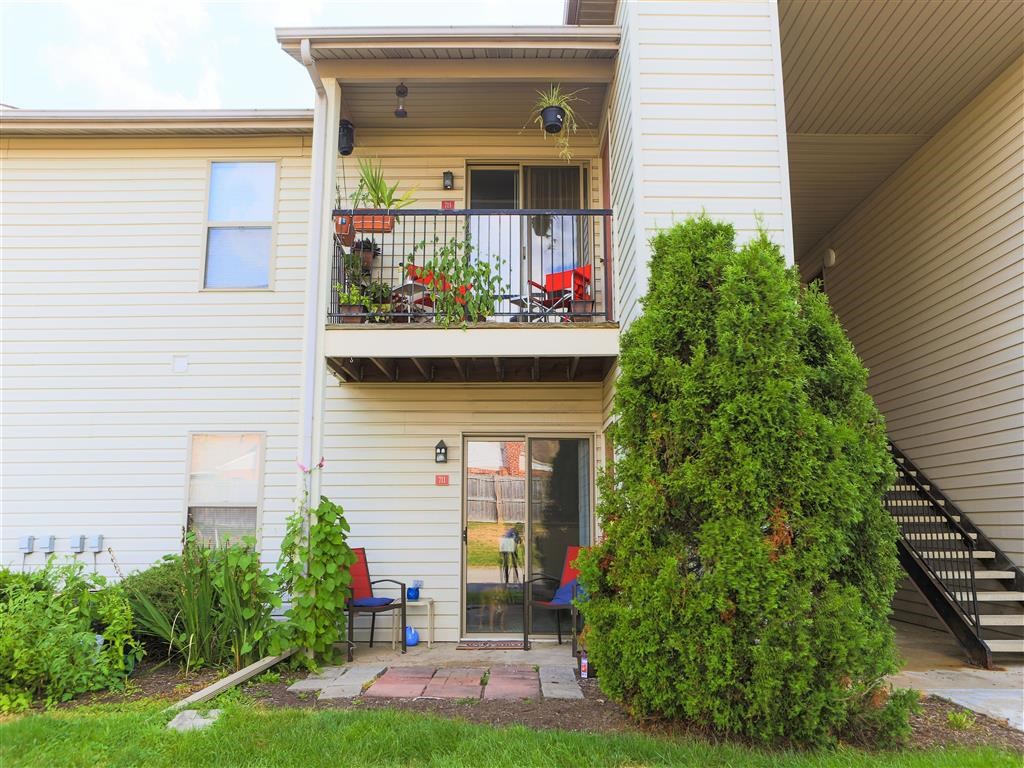 a white house with a balcony and a garden