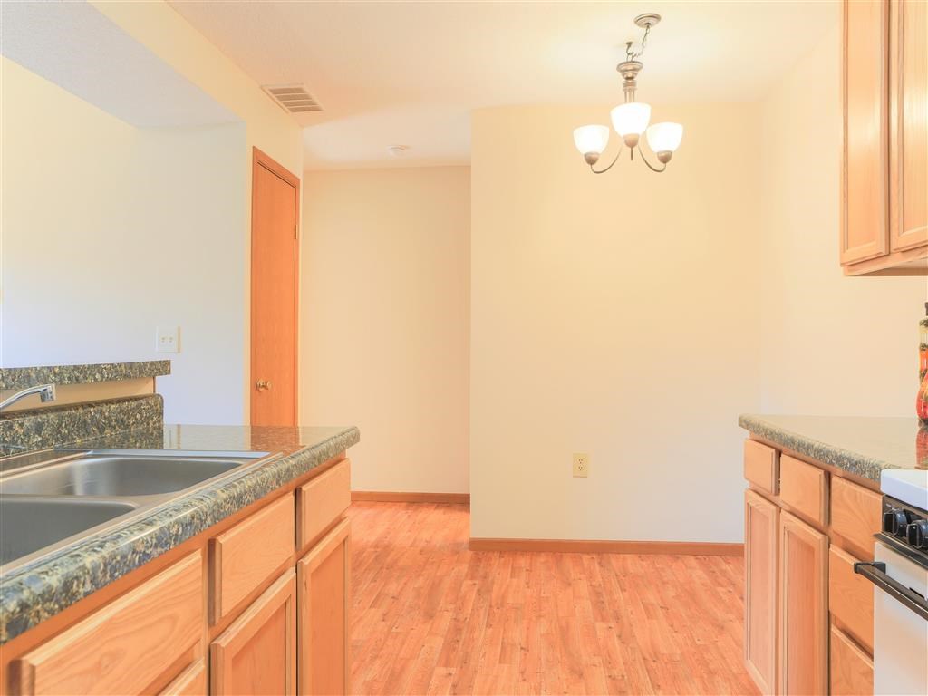 a kitchen and living room with wood flooring and a counter top