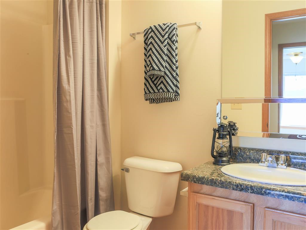 a bathroom with a toilet and a sink and a shower