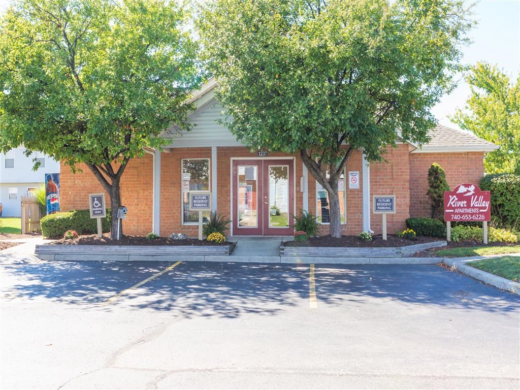 our office is located in a brick building with trees