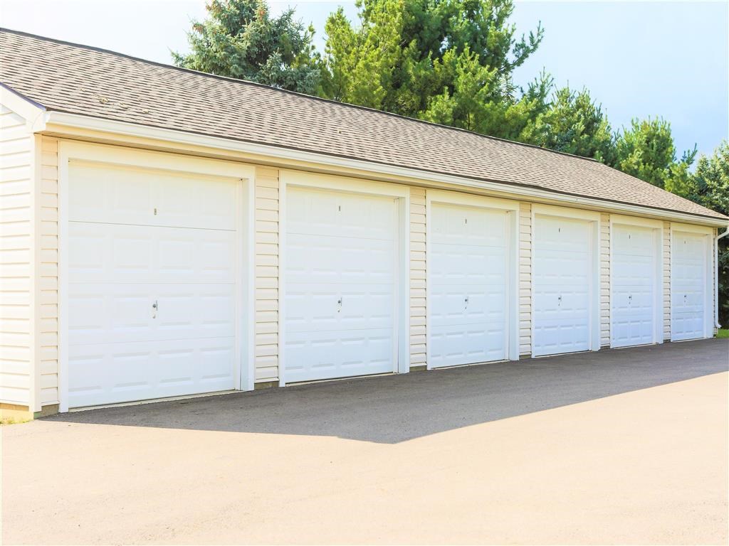a row of white garages with white doors