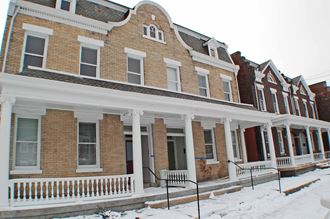 a row of houses in the snow