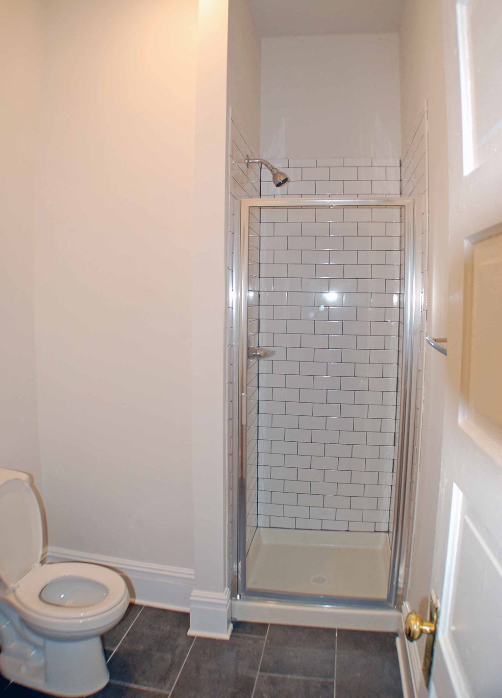 a small bathroom with a shower and a toilet