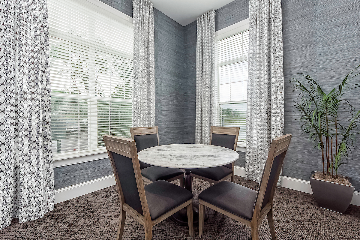 a dining room with a table and chairs