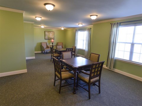 A dining room with a table and chairs.