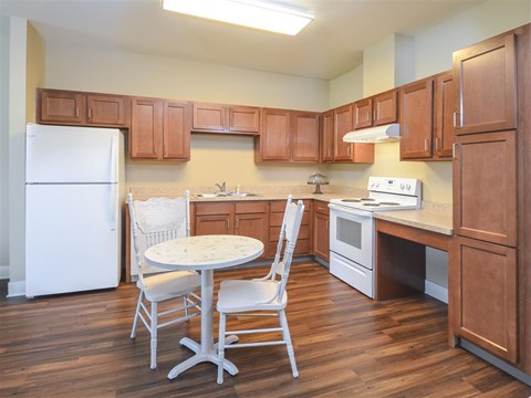 A kitchen with wooden cabinets and a white refrigerator.