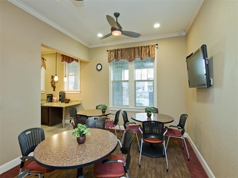 A dining room with a round table and chairs.