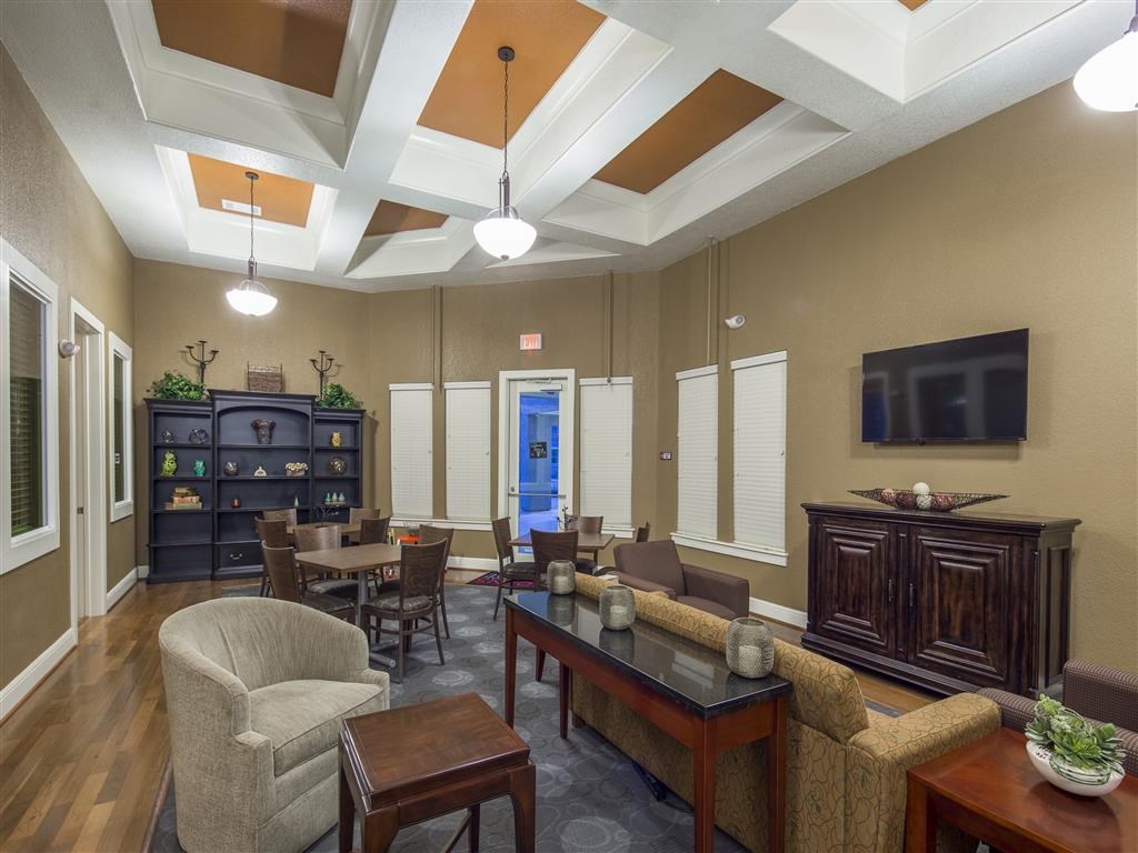 a living room with a table and chairs and a television