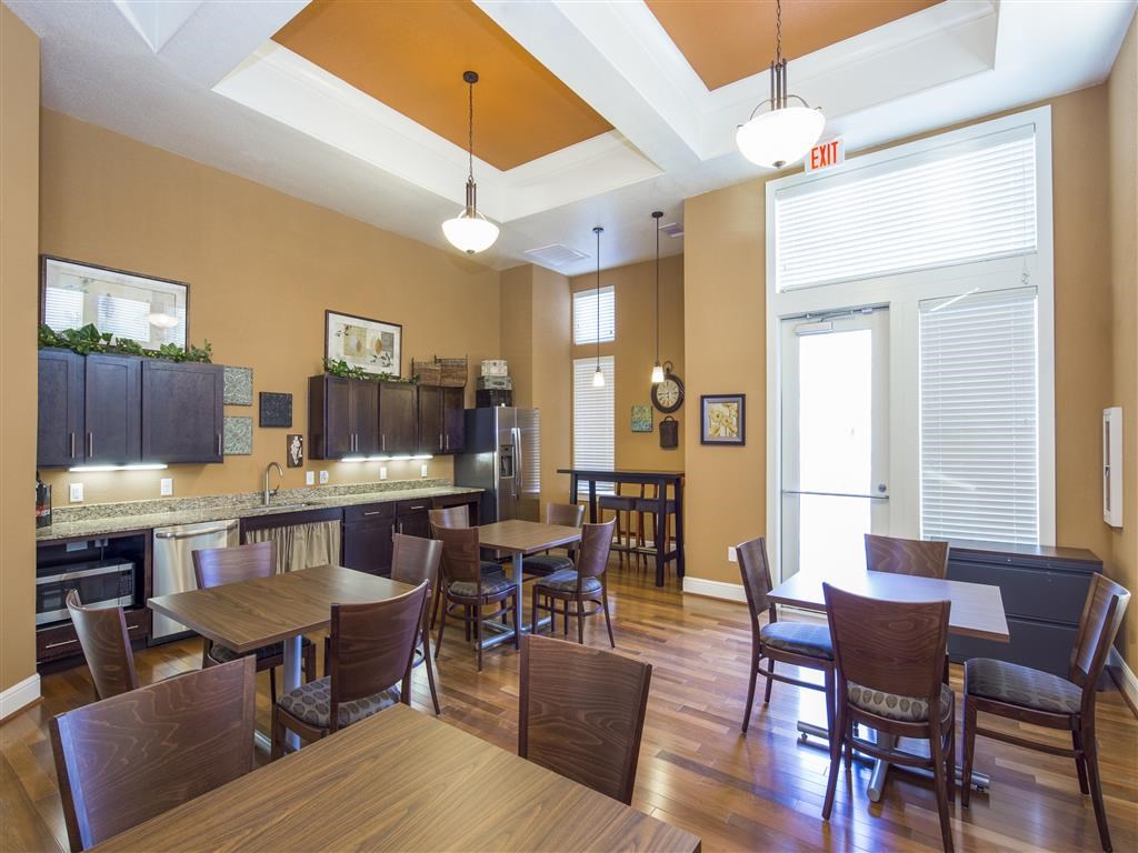 a dining room and kitchen with tables and chairs