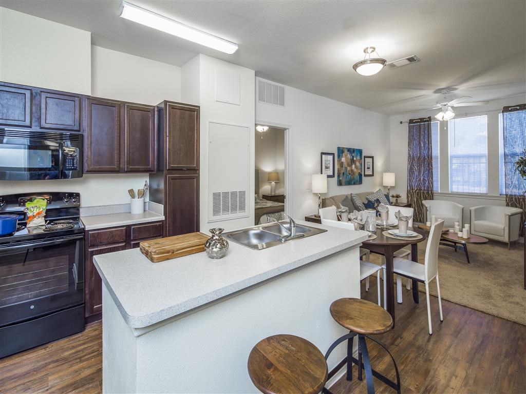 a kitchen and living room with a counter top