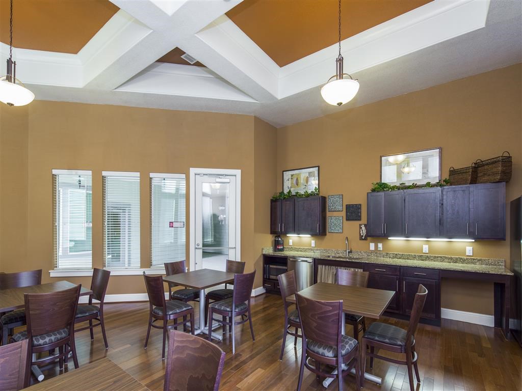 a dining room with tables and chairs and a bar