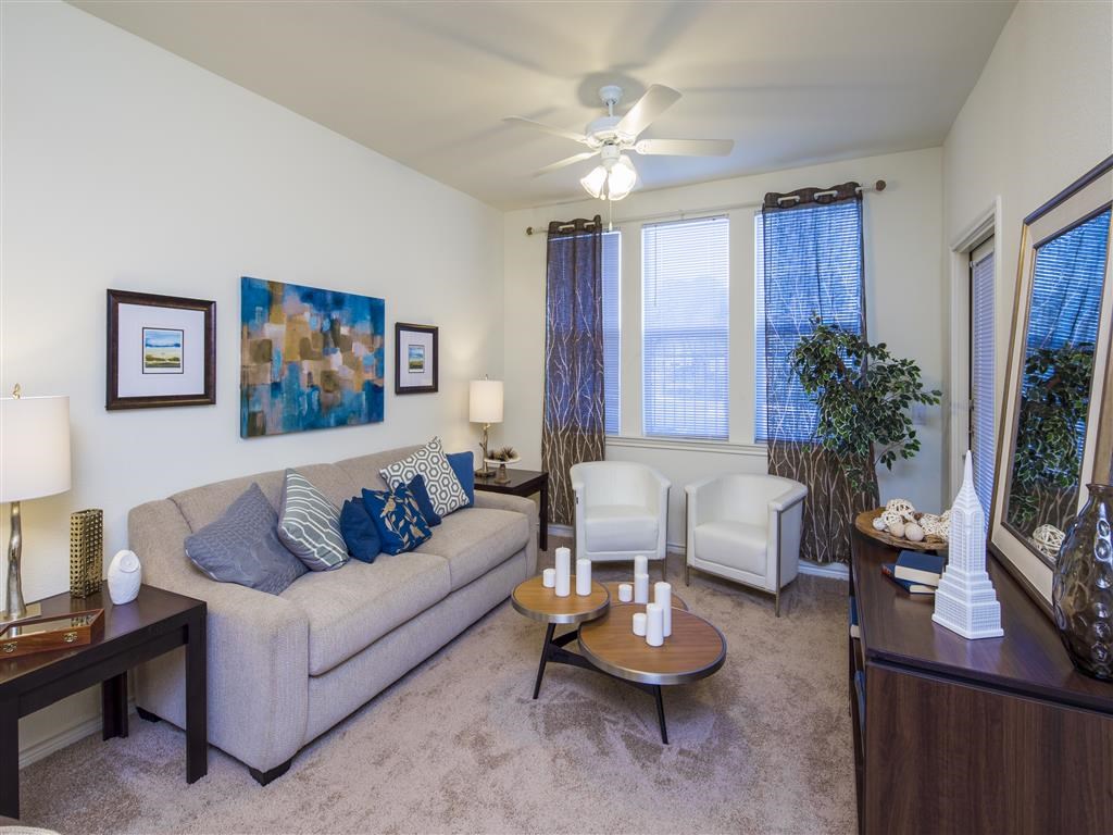 a living room with a couch and a ceiling fan