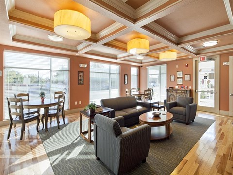 A living room with a dining table and chairs.