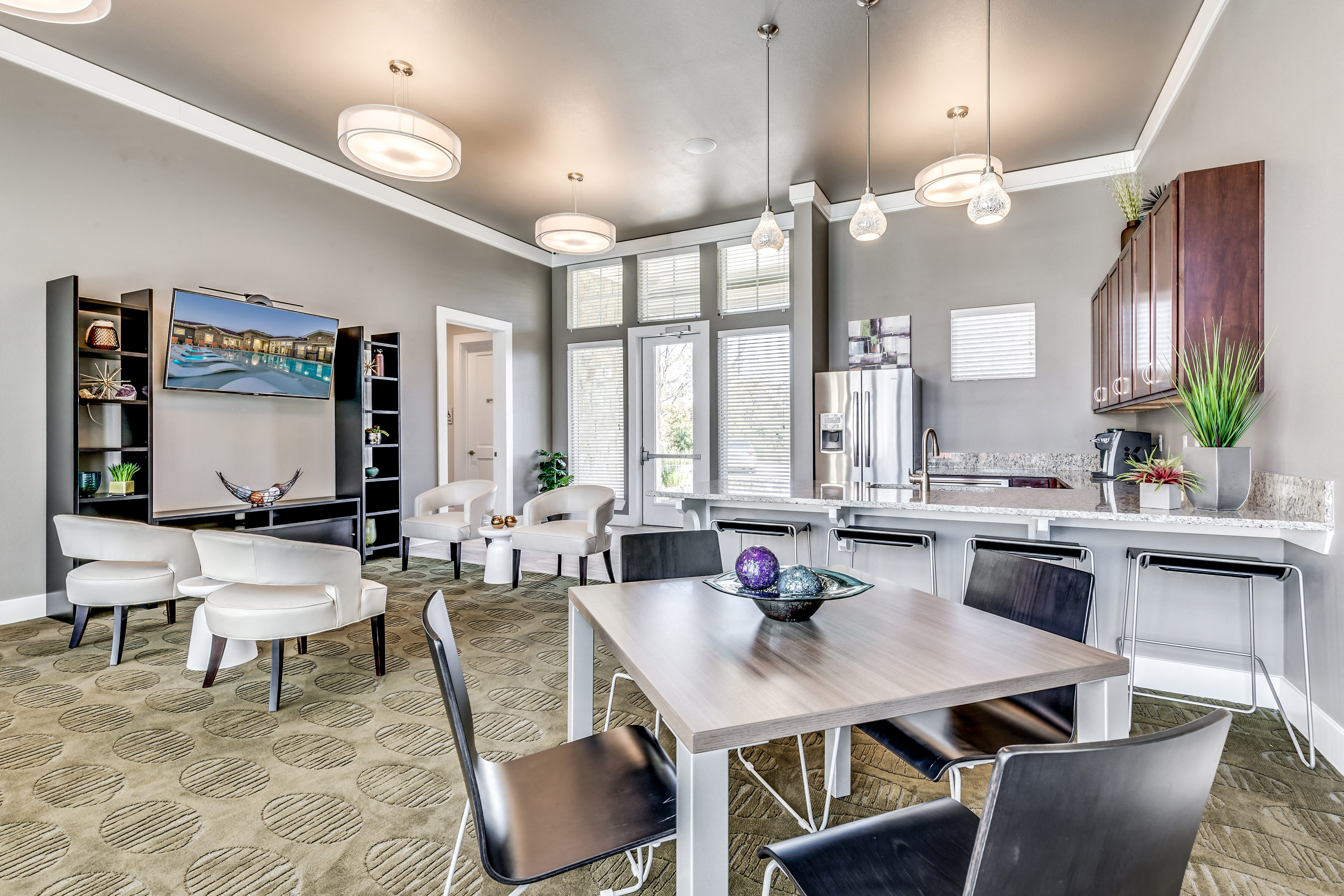 A modern living room with a dining table and chairs.