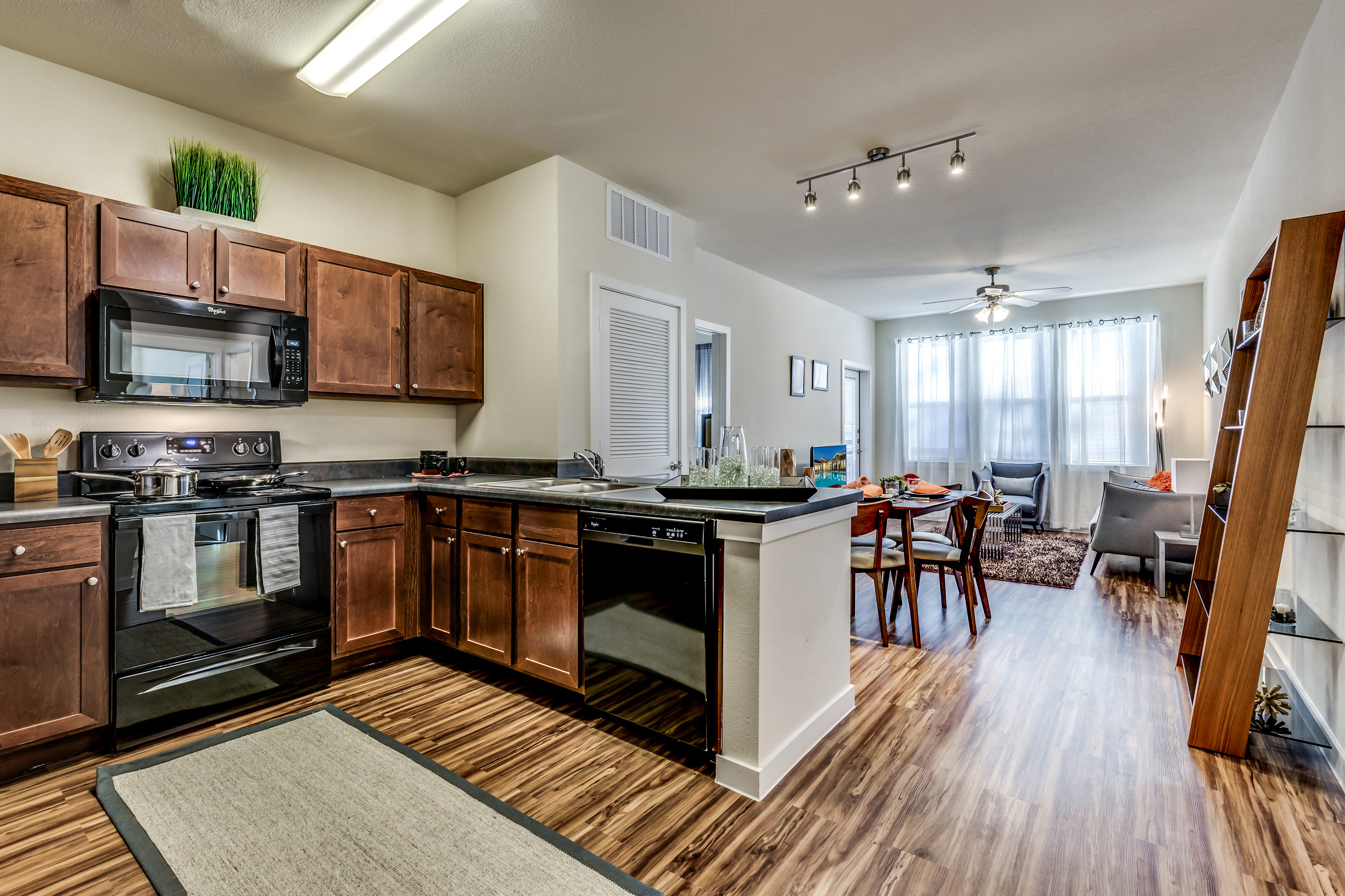 A kitchen with wooden cabinets and a black stove top oven.