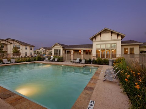 Resort-style swimming pool with comfortable lounge seating and a beautifully maintained outdoor space designed for relaxation.