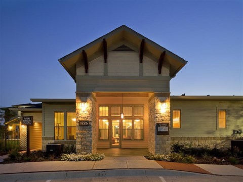 Modern apartment community featuring contemporary architecture, beautifully maintained landscaping, and inviting curb appeal.